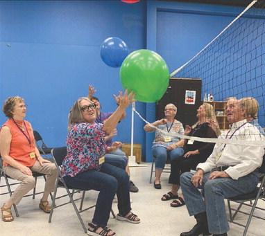 Volunteers demonstrated balloon volleyball on Oct. 13 to warm up the court prior to the guests arriving. Pictured, from left, are: center director Allie Bennett and volunteers Debbie Pridgeon, Kelley Harbert, Mary Edmondson, Marilyn Gottfredson, Michael LeVitt and Allen Laughlin. Also, playing but obscured behind participants are: Traci Reeves and Barbara Van Tassel. Contributed photo