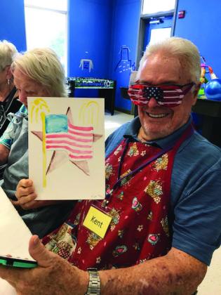 Wesley Respite Center volunteer Kent Gottfredson likes to put program attendees in a good mood with his creativity as well as a patriotic art project during a get-together at First United Methodist Church with an Independence Day theme.