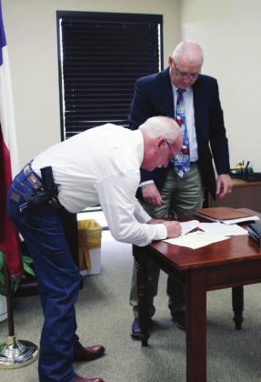 Llano County Judge Ron Cunningham (right) oversaw the ceremony to welcome the new precinct 1 Constable Gary Silver.