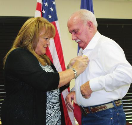 Sam Silver pinned the badge on her husband Gary Silver’s shirt, after he officially became precinct 1 constable on Sept. 1. Photos by Connie Swinney/The Highlander