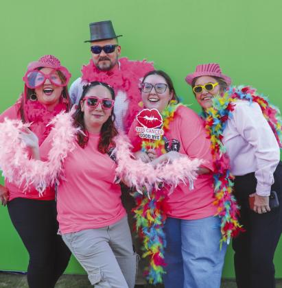 City of Marble Falls employees took full advantage of the Photo Me props. Pictured are (in front) Elina Ellis and (back row) Kristen Jones, Caleb Kraenzel, Hanna Kadow and Kim Foutz at Harmony Park during the 2023 Pink Out Oct. 19. See more photos on Page 10. Martelle Luedecke/Luedecke Photography