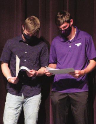 Mustangs seniors Lance Long (left) and Mason Neill share their award certificates with each other on Wednesday. Long was named Academic All-District and Academic All-State. Neill was named teammate of the year by his peers. Nathan Hendrix/The Highlander