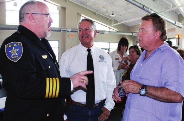 The new Marble Falls Police Chief Glenn Hanson visited with attendees, including Burnet County Pct. 4 Commissioner Joe Don Dockery, center, and Marble Falls Mayor Richard Westerman for the swearing in event and reception at Lakeside Park on June 29. Connie Swinney/The Highlander