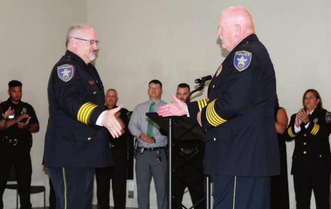 On June 29, outgoing MFPD Chief Mark Whitacre, on the right, congratulated Glenn Hanson, who was previously the assistant chief, on his promotion as the next lead administrator of the local agency. Connie Swinney/The Highlander