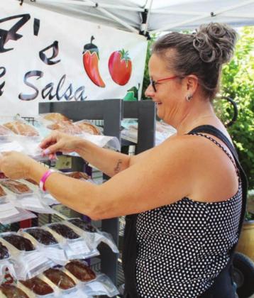Left: Ada Connely of Tow set up her B&amp;A Baked Goods and Salsa booth June 13 at the Marble Falls downtown Open Air Market.