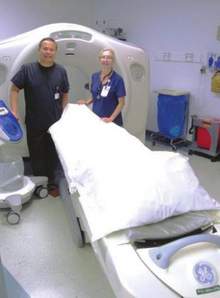 Russell Palmares, left, and Wendy Treibs stand by the hospital’s new computer tomography (CT) scanner. The scanner provides a more detailed view of the body’s interior, giving physicians better information. Photos by Phil Reynolds/The Highlander