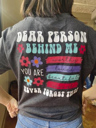 Niamh Fahy, Phoenix Center staff member, models a t-shirt reflecting the values of the participants.