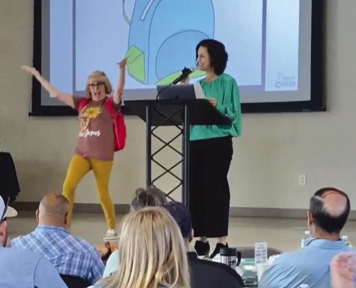 Volunteer Ruth Reed helped Phoenix Center founder and CEO, Sarah Garrett, present 'Backpack Activity' Oct. 10 for World Health Day to demonstrate how different children enter the classroom, equipped with different sets of skills and life experiences.
