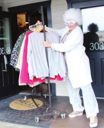 Connie Swinney/ The Highlander On Oct. 14, Kelly Davis of Lula’s on Main organized a set of gift cards for $100 giveaways in anticipation of specials on Saturday, Oct. 16 during the Back to the Future event downtown. Dressed as “Doc Brown” from the movie, she along with several other businesses will participate in themed activities.