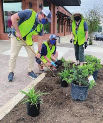 Above right: LCRA employees plant and add mulch to a downtown flower bed in Marble Falls. Photos contributed/LCRA