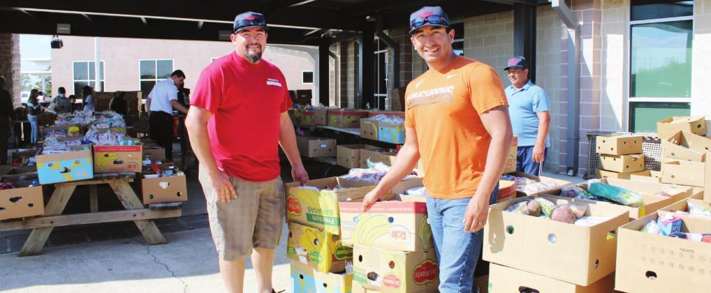 Above: Joseph’s Food Pantry volunteers Robert Najera and Chris Guerrero (right) organized and distributed boxes of nonperishable items to families Nov. 20 at the site of Highland Lakes Elementary School, where organizers also hosted a Thanksgiving lunch.