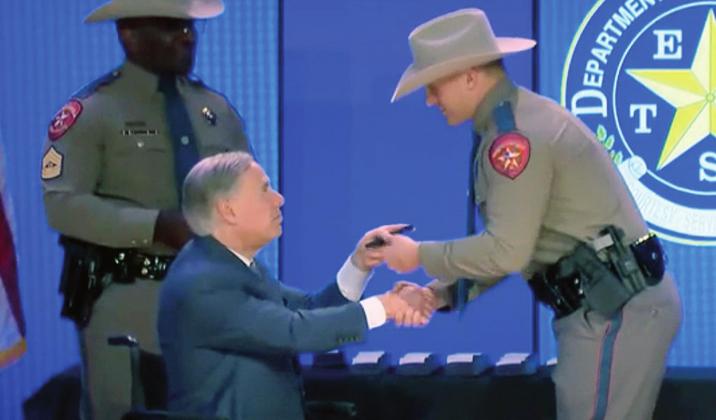 Texas Gov. Greg Abbott, seen here congratulating Granite Shoals native Andrew Mitchell, attended the graduation ceremony on July 30 at the Great Hills Baptist Church in Austin. Contributed
