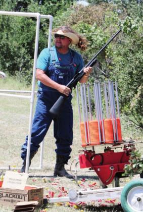 Chris Laird looks the part of a mountain man with his long hair flowing through his hat as he waits for the clays to get fired off at the Shoot for Coop tournament at the Despain Ranch.