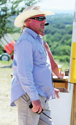 Above, Cameron Travis works as a volunteer helping keep track of shooters’ performances during the annual Shoot for Coop event on Saturday. The event would not be possible without many volunteers and sponsors who help make it a success.