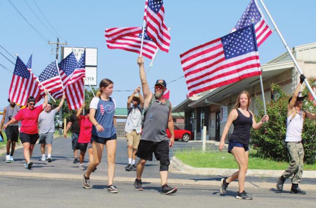 A group of about a dozen Patriot Day marchers traveled U.S. 281 from Kingsland with escorts including a unit from Granite Shoals Police Department. Their journey ended at VFW Post 10376 in Marble Falls. Nathan Hendrix/The Highlander