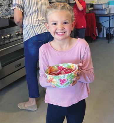 Josie Brasher displays an excitement for sliced radishes like only a child who participates in Art of the Meal’s Kid’s Cooking Camp can. Photos by Judith Shabram/The Highlander