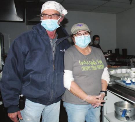 Leonard and Jackie Venghaus, who both work for Marble Falls ISD were among volunteers preparing and serving food to vulnerable residents at the local emergency shelter. Connie Swinney/The Highlander