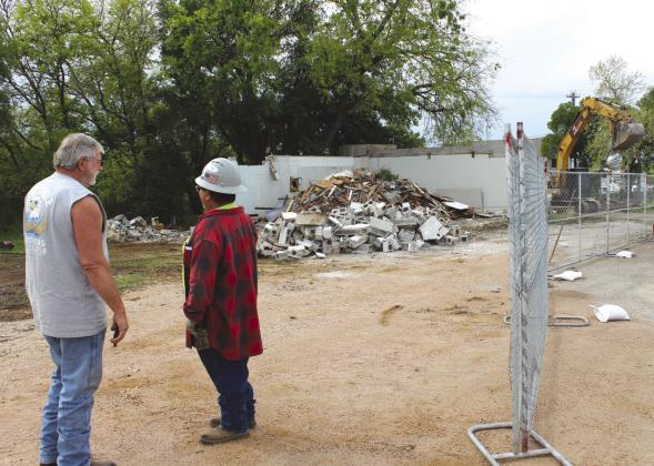 Trucker Lacy Pearson (left) and Flash Demolition crew member Gabriel Osoria were on hand, during the demolition March 27 of buildings on property owned by the Marble Falls EDC. Photos by Connie Swinney/The Highlander