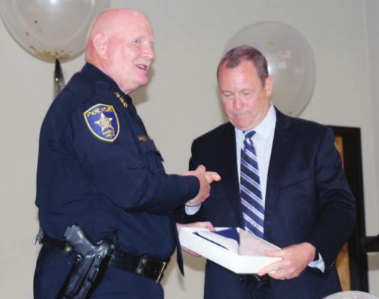 During the retirement event June 25, State Sen. Terry Wilson announced presentation of an American flag to be flown over the state Capitol for a day in honor of Marble Falls Police Chief Mark Whitacre. Photos by Connie Swinney The Highlander