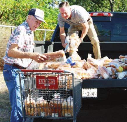 Helping Center of Marble Falls will soon have more room to sort and store food in January when they move to 1016 Broadway. Pictured here, from right, at the current location is 1315 Broadway is Helping Center Executive Director Sam Pearce and center board member Ray Mobley. File photo
