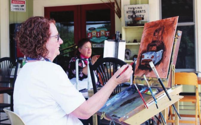 The 14th Annual Paint the Town/Plein Air Juried Competition is going on the week of May 3-8. Pictured on May 4 at a Spicewood event in the foreground is Kathy Hammond of Frenswood. The bulk of the activities are happening in the downtown district of Marble Falls through the rest of the week. Connie Swinney/The Highlander