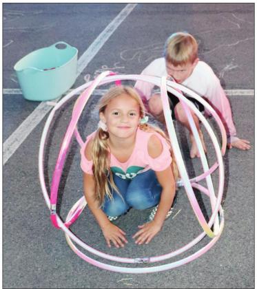  At the event, Claire Payne (at right) and her brother had fun with hula hoops. Contributed/Amanda Langley