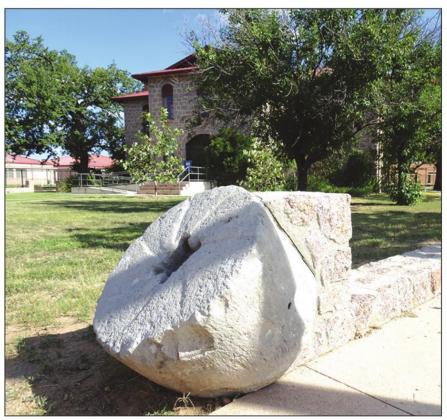 An old mill stone is now part of an historic wall in Marble Falls near the Falls on the Colorado Museum. Contributed