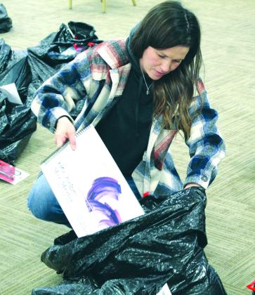 Burnet resident Sydney Carrasco inserted a sketch book into a bag full of other goodies Dec. 16 in Burnet at the Texas AgriLife Extension.