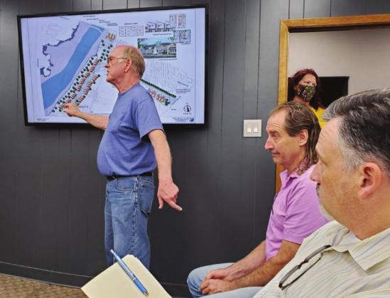 Nearby resident Tom Schwier, pictured here with adjacent business owner John Davis (far right), warned city council members about the potential for flooding, limited emergency access and proximity of increased traffic near his home. Connie Swinney/The Highlander