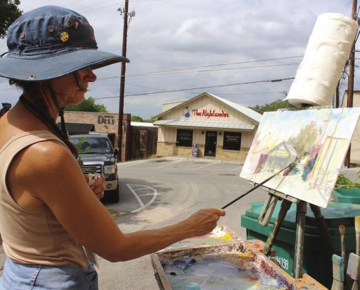 Shea Daniel-Youngblood, who set up in the 900 block of Third Street, was among artists April 24 who selected scenes to paint, during Marble Falls Paint the Town. Connie Swinney/The Highlander