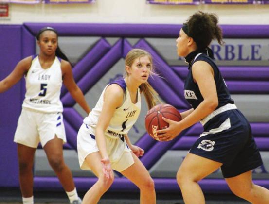 The Lady Mustangs defense put plenty of pressure on Wolves ball handlers on Friday night. Alyssa Berkman (front) and Gia Lemon were a key part of the perimeter defense until Berkman fouled out in the fourth quarter. Berkman also knocked down a pair of three-point shots to kickstart the Marble Falls second half comeback. Nathan Hendrix/The Highlander