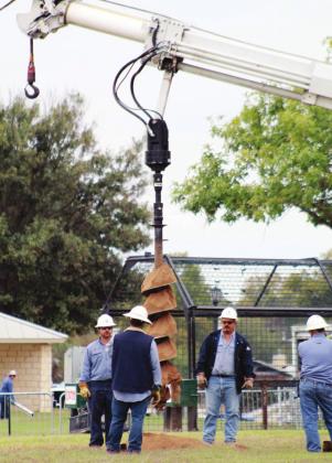 On Nov. 8, a Pedernales Electric Cooperative crew drilled holes to install poles for the light displays at the Walkway of Lights on the shoreline of Lake Marble Falls.