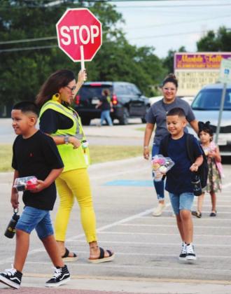 Left: Amy Valdez brought the joy with dancing and laughs while performing her duties as crosswalk supervisor.