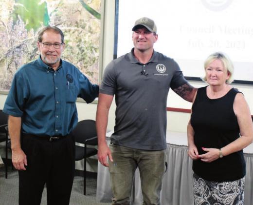 Gerrad Cranfill, center, is honored by HSB public works director Jeff Koska, left, and Mayor Cynthia Clinesmith at Tuesday’s meeting. Lew K. Cohn/The Highlander