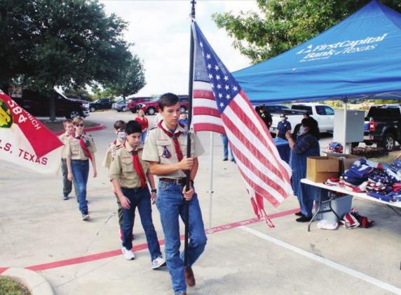 An honor guard - William Eppler, Dane Bowers, Jonathan Leflet, Aiden McCloughan and Avery Kent - from Boy Scout Troop 284 of Marble Falls carries in Old Glory to be retired during a Saturday, Nov. 7 ceremony at FirstCapital Bank of Texas. More than 100 old, unusable flags were disposed of by burning during the event. Photos by Lew K. Cohn/The Highlander 