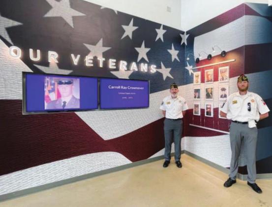 Members of VFW Post 10376, including veterans Vic Zack (left) and Alan Martin III, will work with MFISD officials on finding and featuring alumni who went on to serve in the armed forces. The memorial wall is located in the foyer of the high school. File photo