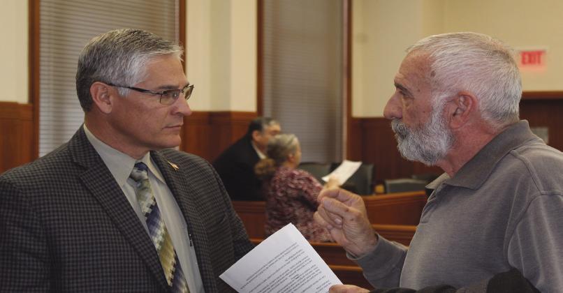 Burnet County Sheriff's Office Chief Deputy Alan Trevino (left) chats with Bertram resident Charlie Parker after the Burnet County Commissioners Court meeting ended Jan. 23. Photo by Raymond V. Whelan/The Highlander