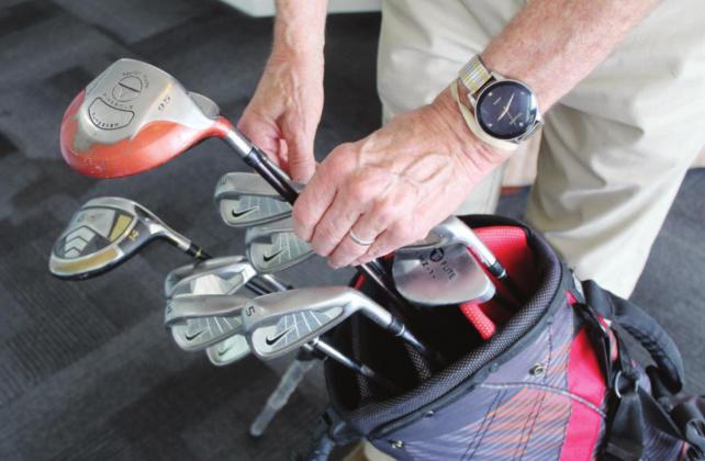The lost-and-found clubs hold sentimental value for Bernie Sachs. The putter, 7-wood and bag were given to him by his son. Connie Swinney/The Highlander
