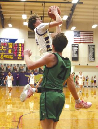 Marble Falls senior guard Kody Smith keeps his concentration while Burnet senior Trey Petty defends.