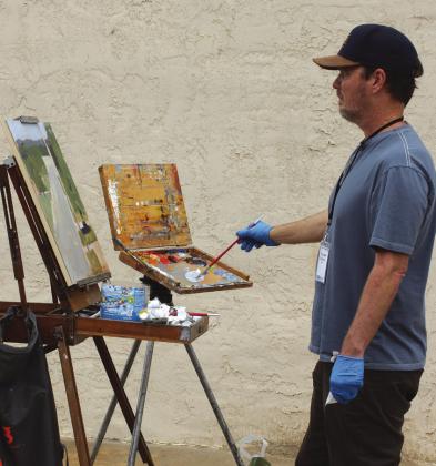 Randall Cogburn, staged on Third Street just off Main, is one of three dozen artists who are in Marble Falls this week participating in the Paint the Town Festival. Connie Swinney/The Highlander