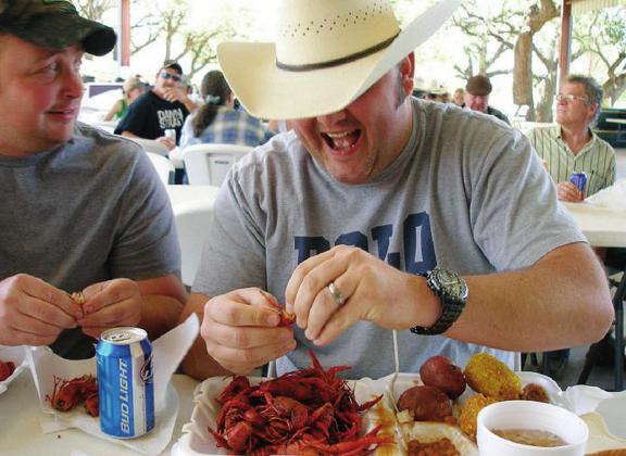 Pinch, push, twist and pull: That’s the best method for getting the most out of your crawfish as these gentlemen demonstrate at a past Llano Crawfish Open. This year’s Open will be held April 16-17. Contributed