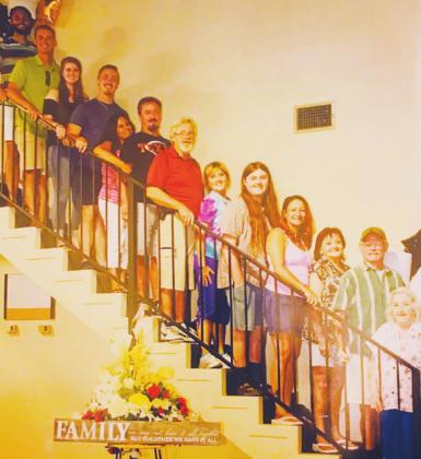 Family photo 6/30/19 @ Wilma Jackson’s birthday party; (Note: the sign below the staircase was one of Mom’s birthday gifts, reading “FAMILY: We may not have it all together, but together we have it all.” This will one day be true again. SSUES...