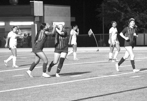 Miley Bolanos (8) and Presley Kahl high-five each other after Bolanos assisted Kahl on the final goal of the win against Jarrell.