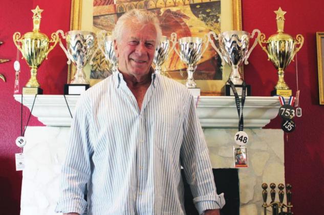 Ed Thompson has trophies and medals lining his mantel, on top of his tables and decorating his office space from his years of dominating in the world of bodybuilding. Nathan Hendrix/The Highlander