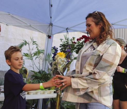 Luke Griffith shared a bouquet with his mom Megan, during the 23rd Annual Hill Country Lawn and Garden Show on March 25 in Burnet.