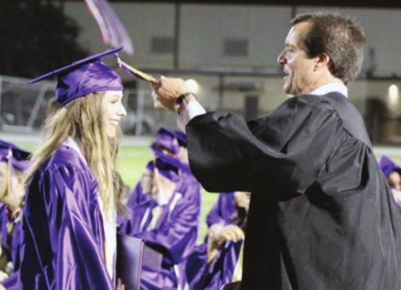 Right: Assistant Principal Clark Fields was selected by the students to turn the tassel signifying graduation. Graduate Kylee Randall was all smiles while he performed the ceremonious act.