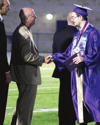Above: MFISD Trustee Rick Edwards always gives firm, sincere handshakes. It was no different with graduate Tanner Clakley.