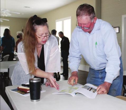 Connie Swinney/The Highlander Spicewood landowners Linda Wall and Johnny Bindseil viewed materials provided during a meeting to launch a comprehensive research about the Cypress Creek watershed including Krause Springs.