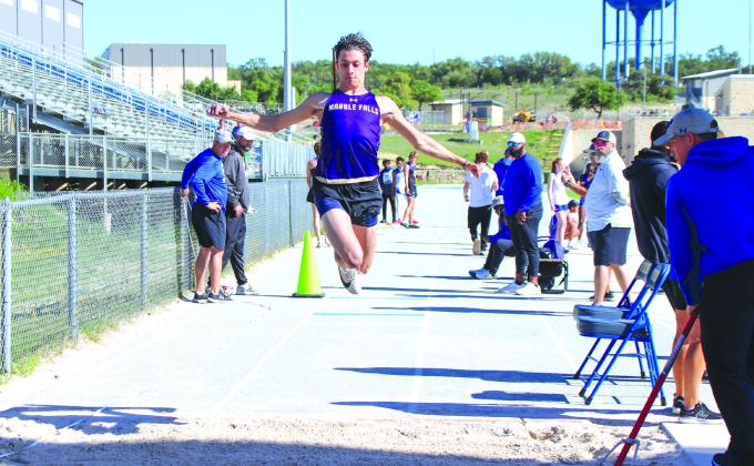 Marble Falls senior Cameron Graham leaps for gold in the triple jump at the District 24-4A meet April 2.