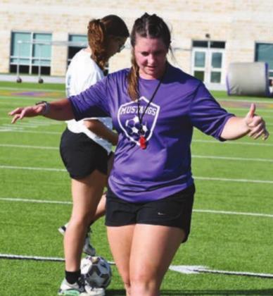 Coach Abigail Blunt shows campers different ways to control the soccer ball during the camp that runs this week at Marble Falls High School.